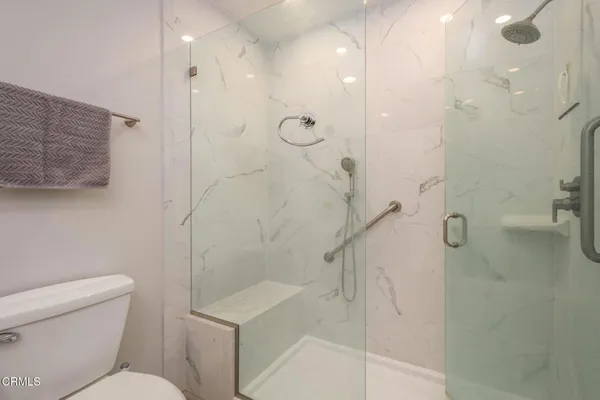 a bathroom with a shower a toilet and sink