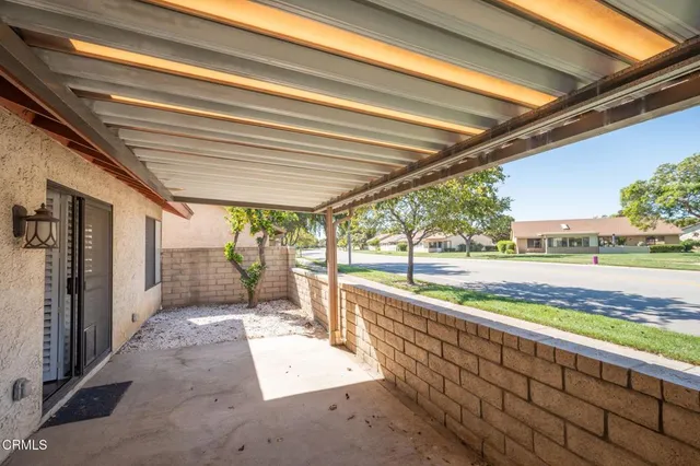 a backyard of a house with plants and wooden fence