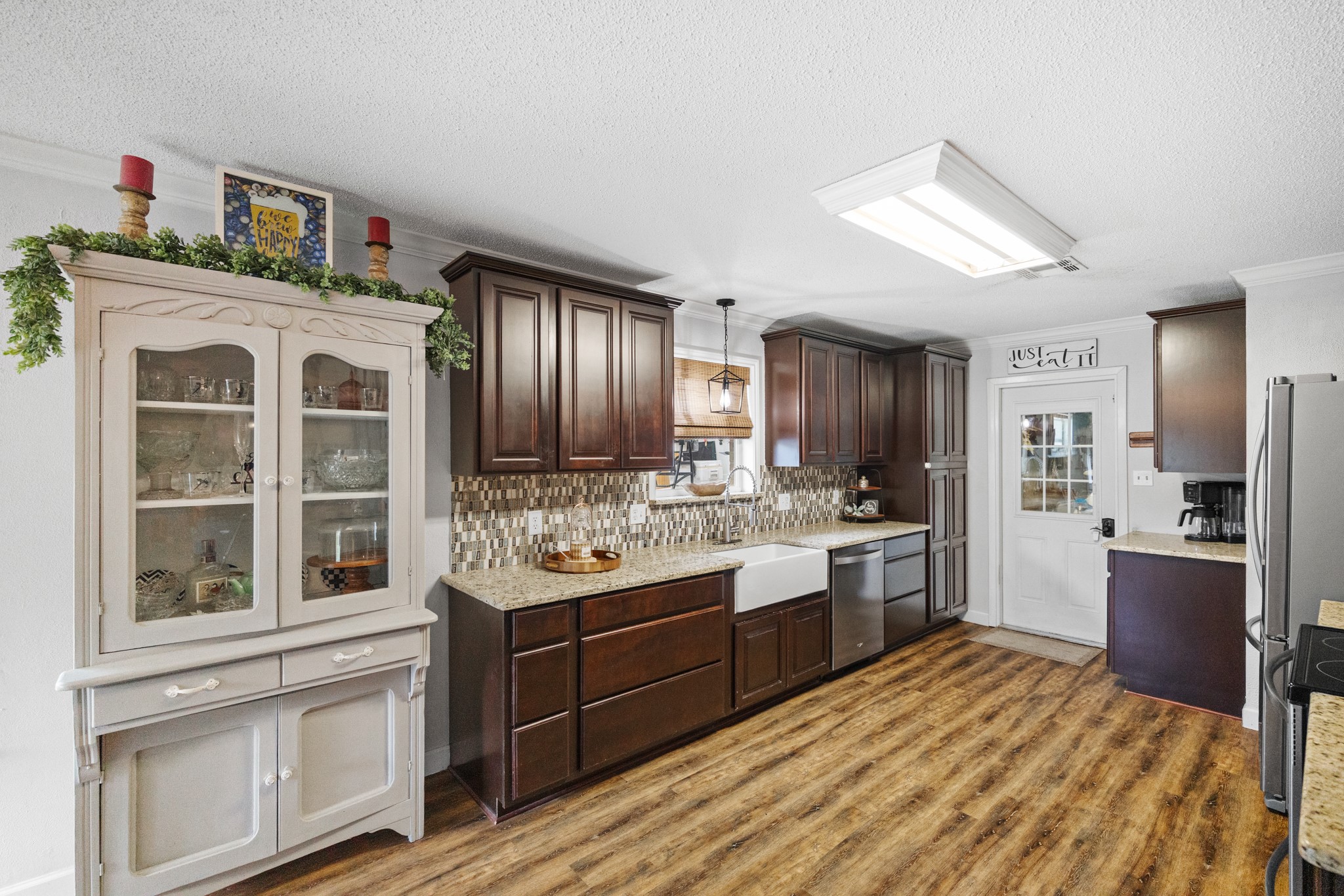 1003 Virginia Street Edna, TX 77957 - Photo 10 of 30 a large kitchen with stainless steel appliances granite countertop a stove and a refrigerator