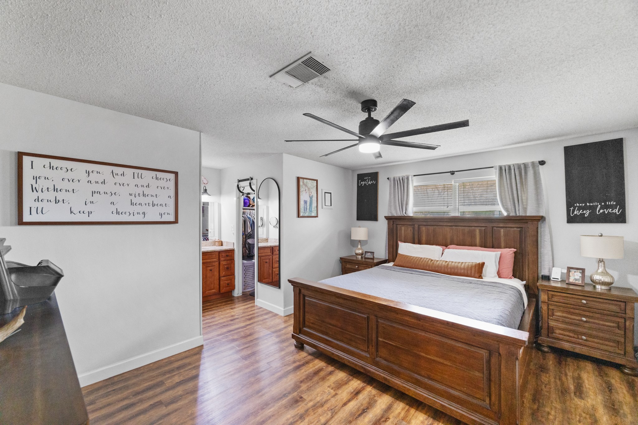 1003 Virginia Street Edna, TX 77957 - Photo 11 of 30 a bedroom with a bed and wooden floor