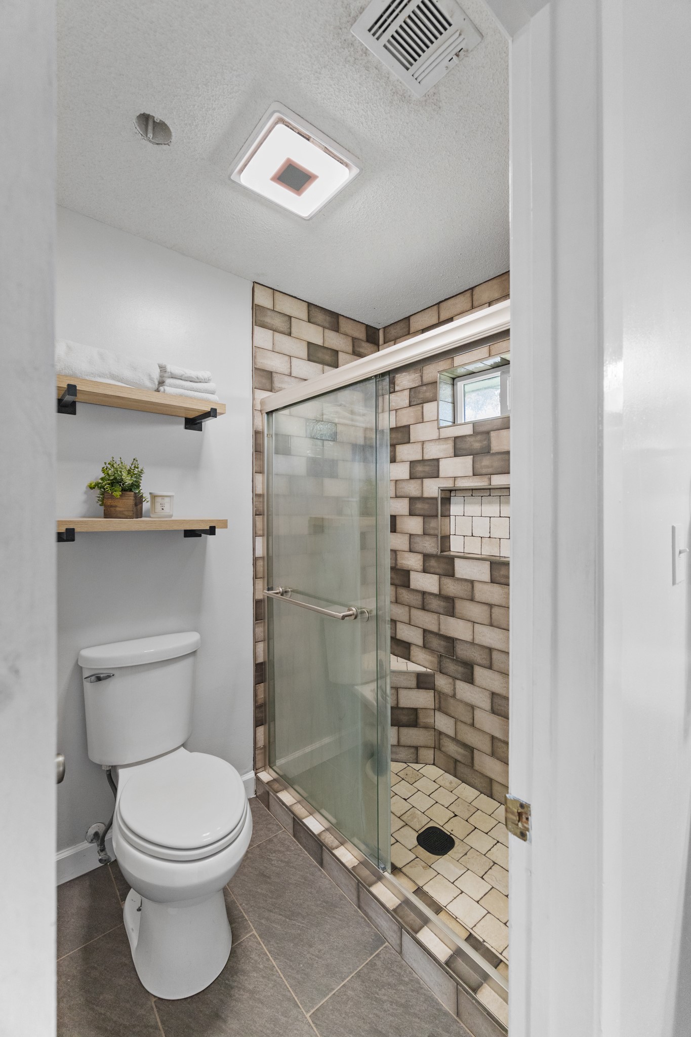 1003 Virginia Street Edna, TX 77957 - Photo 13 of 30 a bathroom with a toilet and a shower
