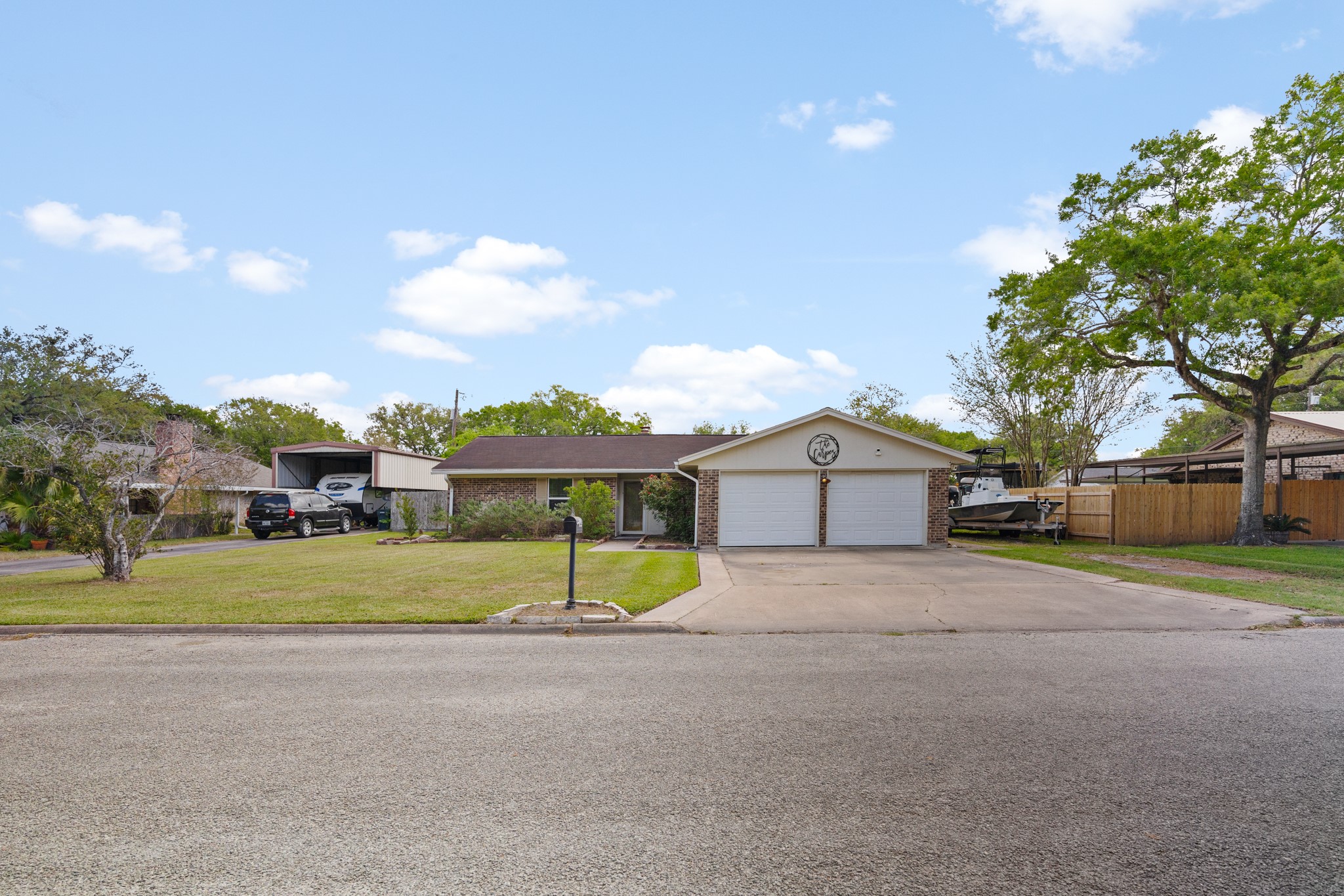 1003 Virginia Street Edna, TX 77957 - Photo 2 of 30 a front view of a house with a yard and garage