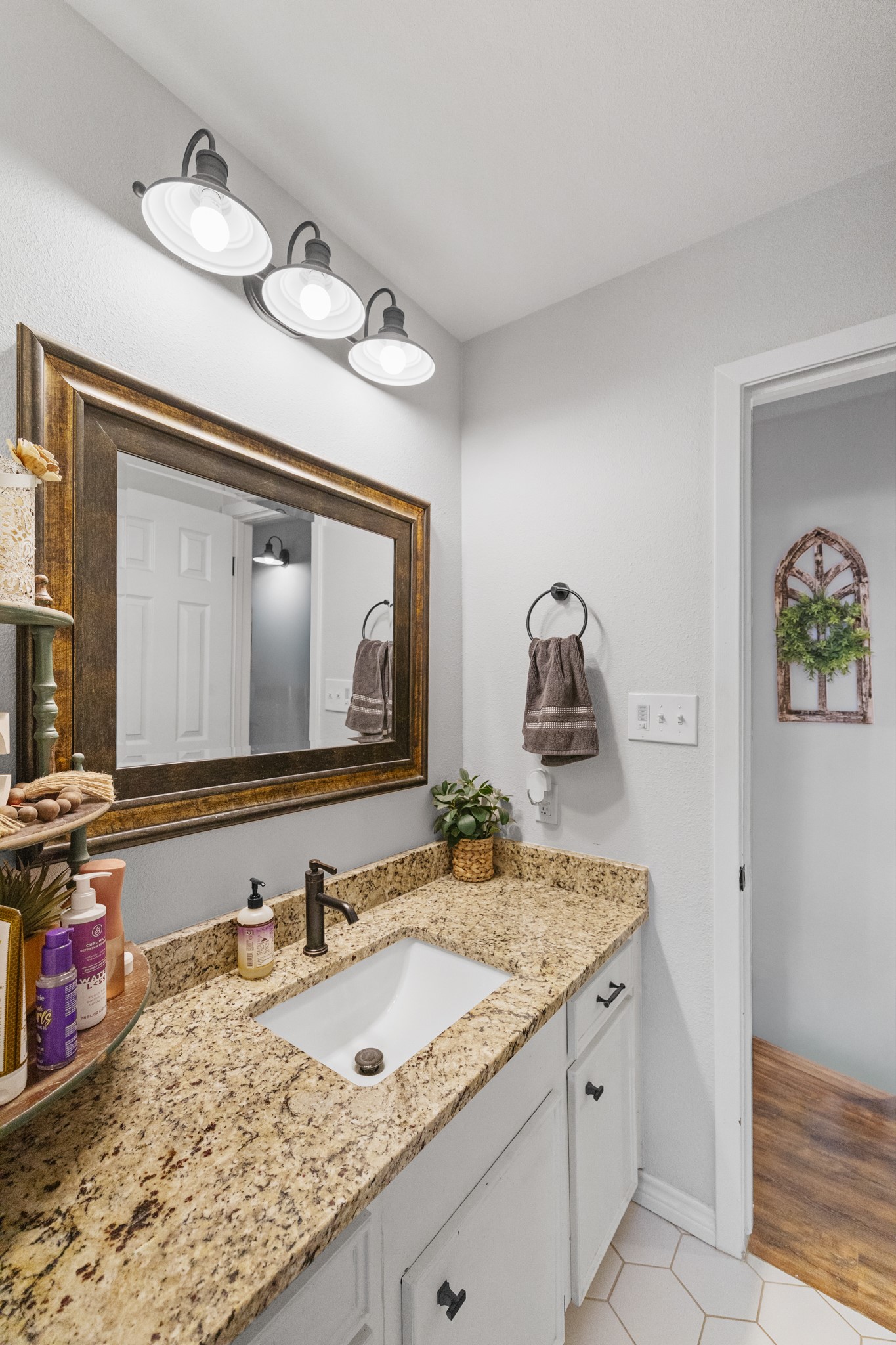 1003 Virginia Street Edna, TX 77957 - Photo 21 of 30 a bathroom with a granite countertop sink and a mirror