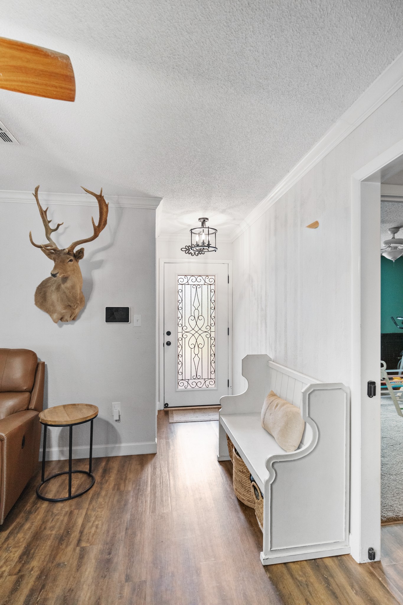 1003 Virginia Street Edna, TX 77957 - Photo 3 of 30 a living room with a couch and a chandelier