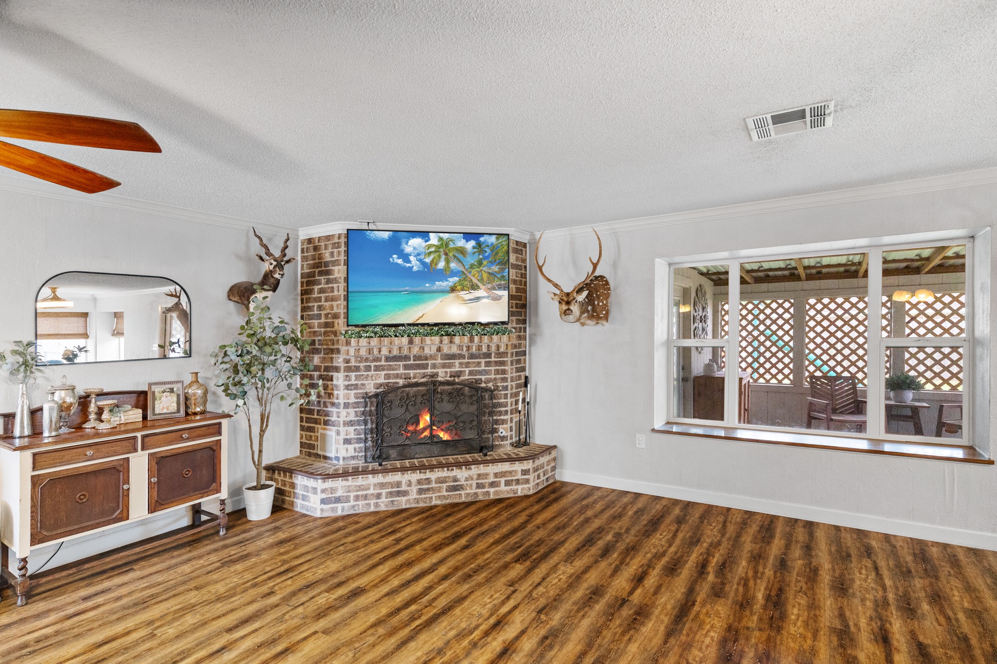 1003 Virginia Street Edna, TX 77957 - Photo 5 of 30 a view of a livingroom with wooden floor and a fireplace