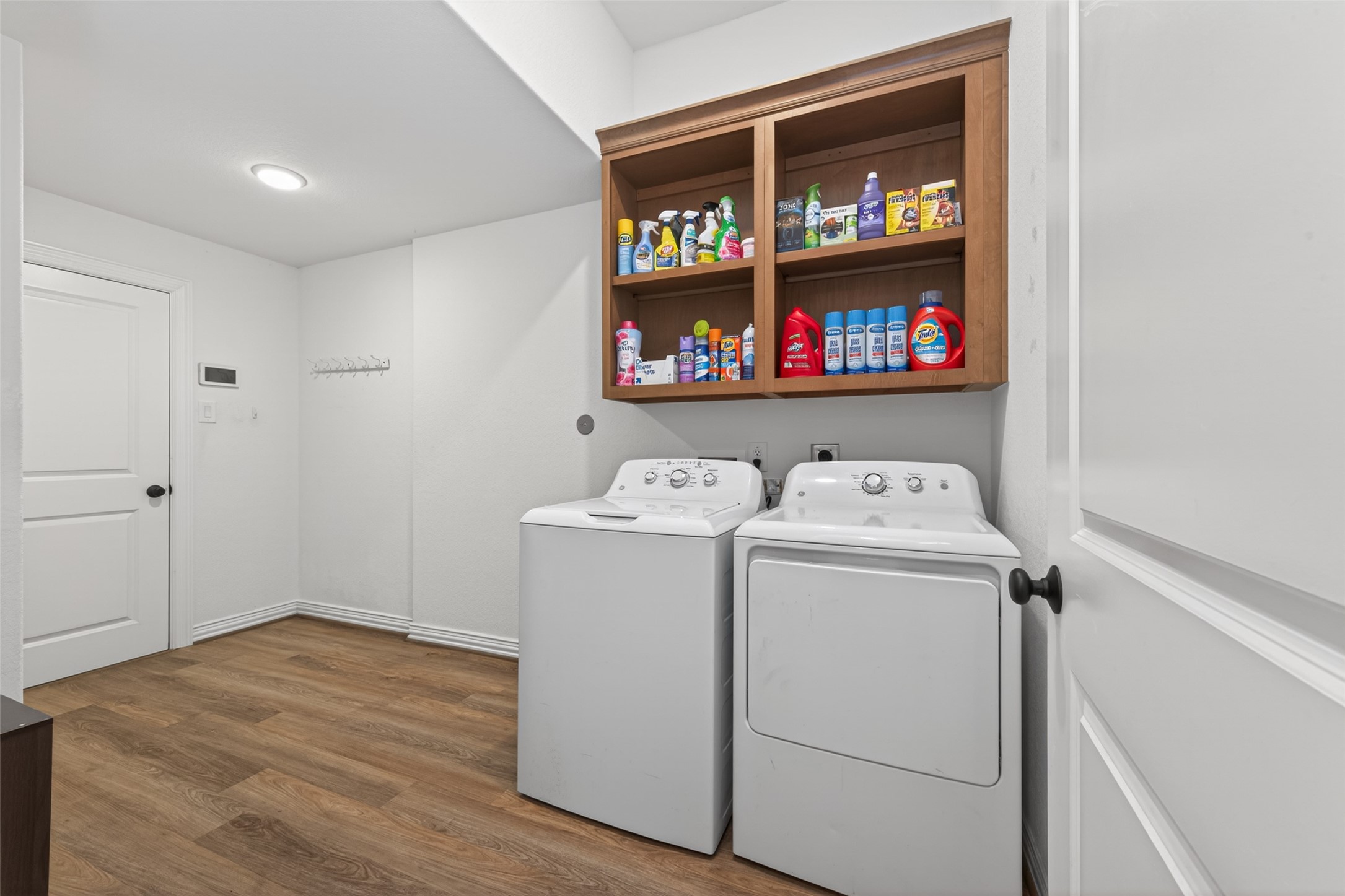20802 Mirror Point Drive Cypress, TX 77433 - Photo 31 of 37 Bright and spacious laundry room featuring ample storage with overhead shelves, presenting a clean, modern aesthetic. The space is well-lit, creating an inviting and functional area for household chores.