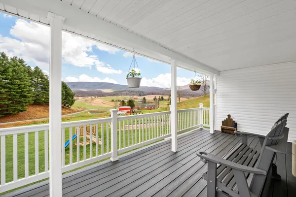 a view of swimming pool with an outdoor seating and many windows