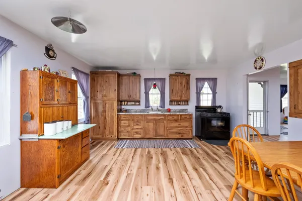 a kitchen with granite countertop wooden cabinets stainless steel appliances a sink and a window