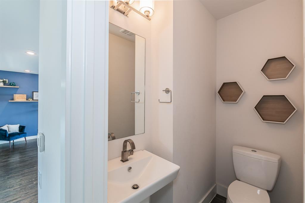 2441 Thatcher Drive Dallas, TX 75206 - Photo 18 of 35 a bathroom with a toilet sink a mirror and vanity