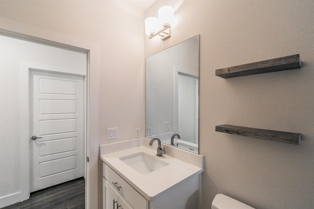 2441 Thatcher Drive Dallas, TX 75206 - Photo 23 of 35 a bathroom with a sink and a mirror