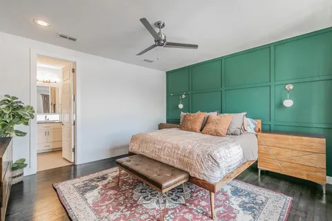 a bedroom with a bed and a flat tv screen