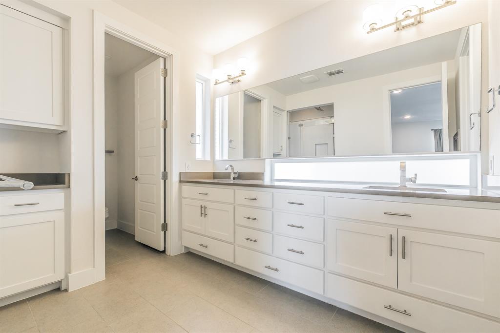 2441 Thatcher Drive Dallas, TX 75206 - Photo 27 of 35 a spacious bathroom with double sink and a large mirror