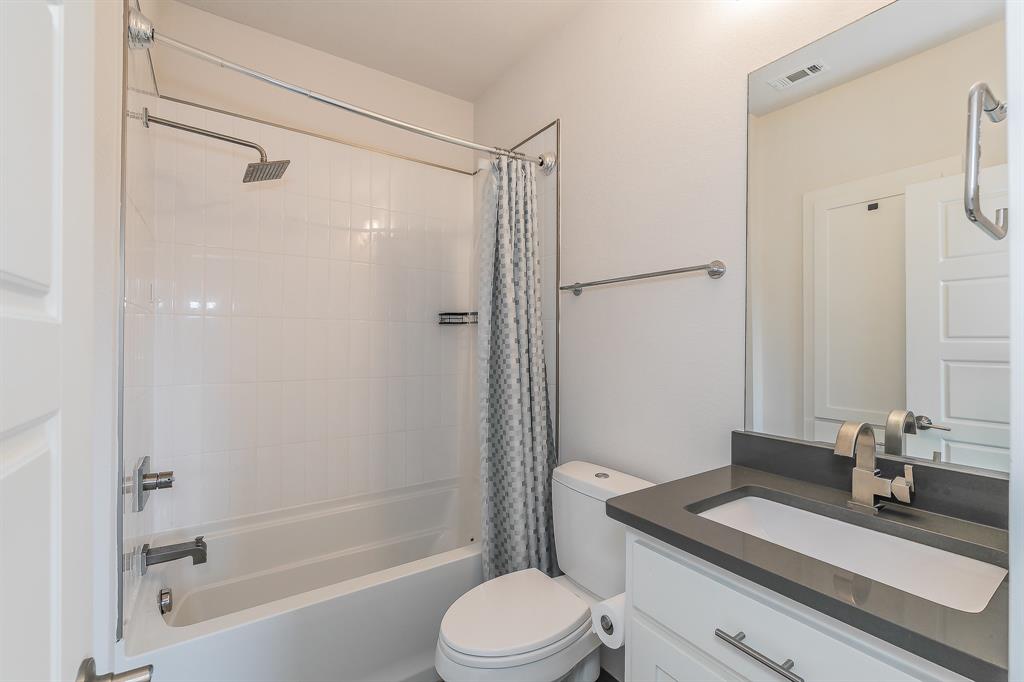 2441 Thatcher Drive Dallas, TX 75206 - Photo 6 of 35 a bathroom with a sink a toilet and shower