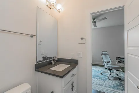 a bathroom with a sink toilet and shower