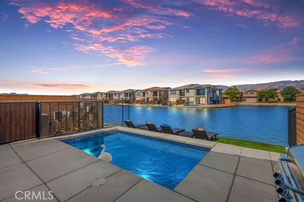 a view of swimming pool with outdoor seating and city view