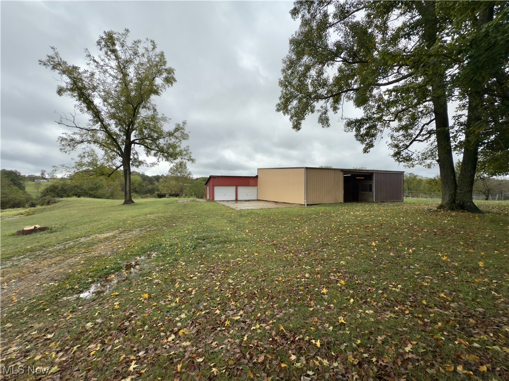 2109 Bell Road Vincent, OH 45784 - Photo 3 of 49 View of green lawn with an outdoor structure, an outbuilding, and a garage
