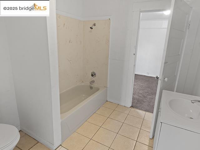 1655 East 32nd Street, Unit 1655 Oakland, CA 94602 - Photo 6 of 12 Bathroom with vanity, light tile patterned floors, and washtub / shower combination