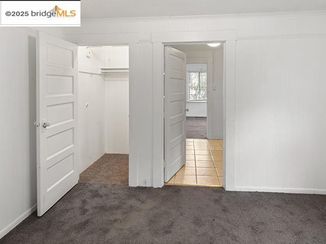 1655 East 32nd Street, Unit 1655 Oakland, CA 94602 - Photo 8 of 12 Unfurnished bedroom with dark carpet and crown molding
