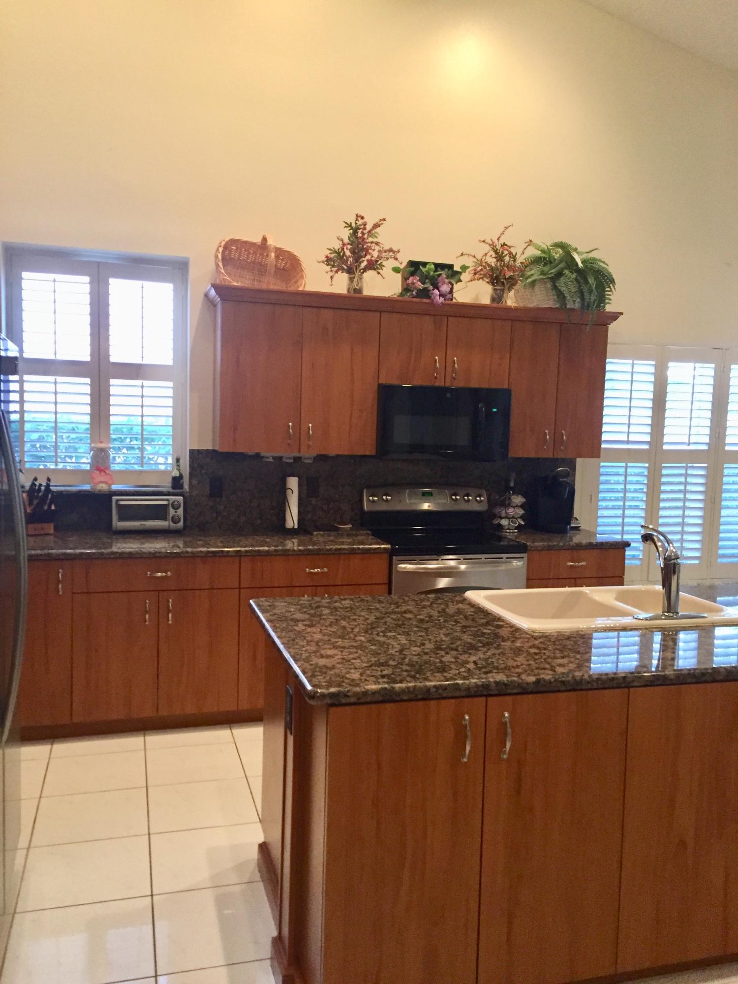 8349 Horseshoe Bay Road Boynton Beach, FL 33472 - Photo 2 of 20 a kitchen with a sink and a cabinets