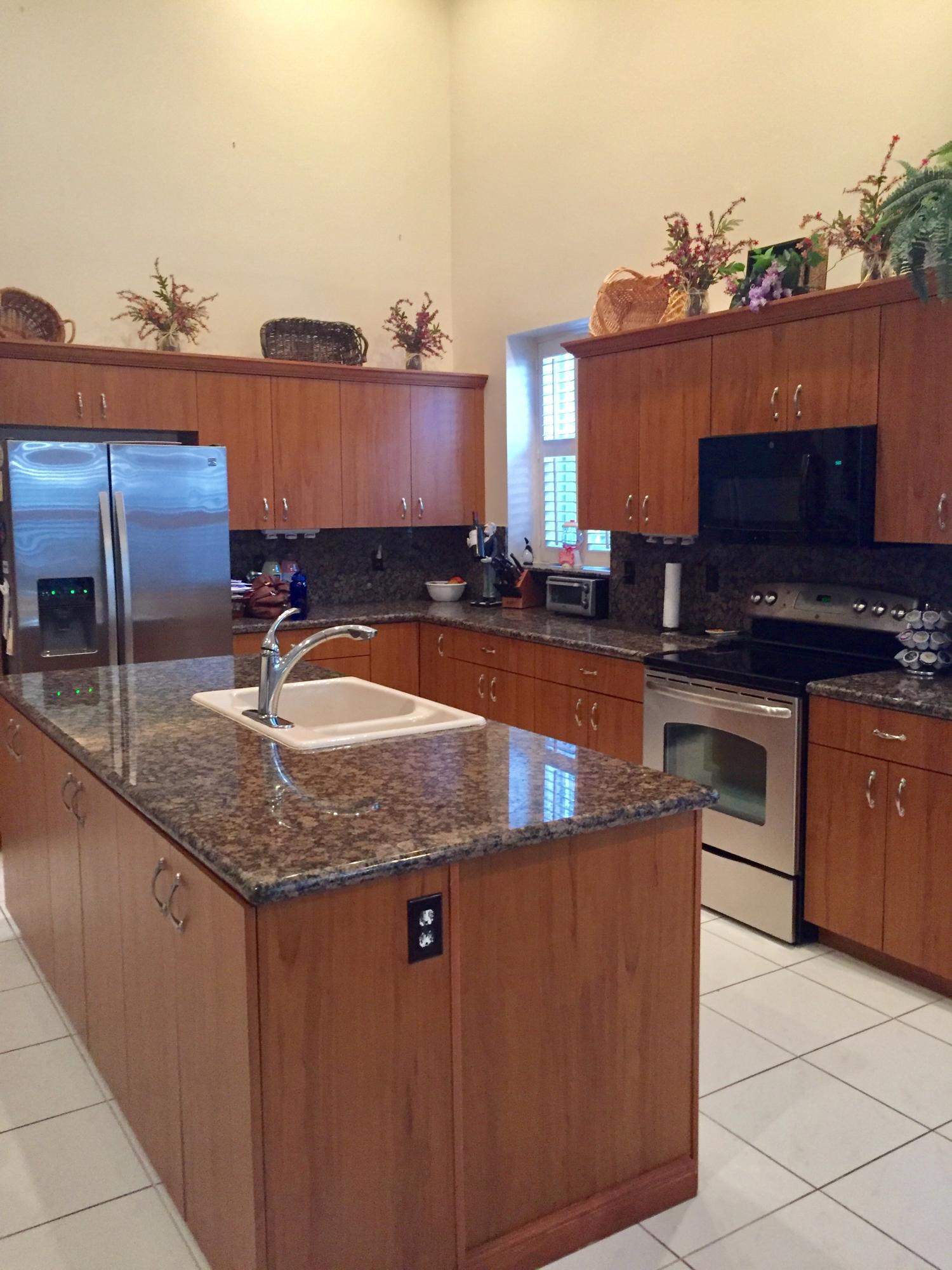 8349 Horseshoe Bay Road Boynton Beach, FL 33472 - Photo 3 of 20 a kitchen with stainless steel appliances granite countertop a sink a stove and a microwave