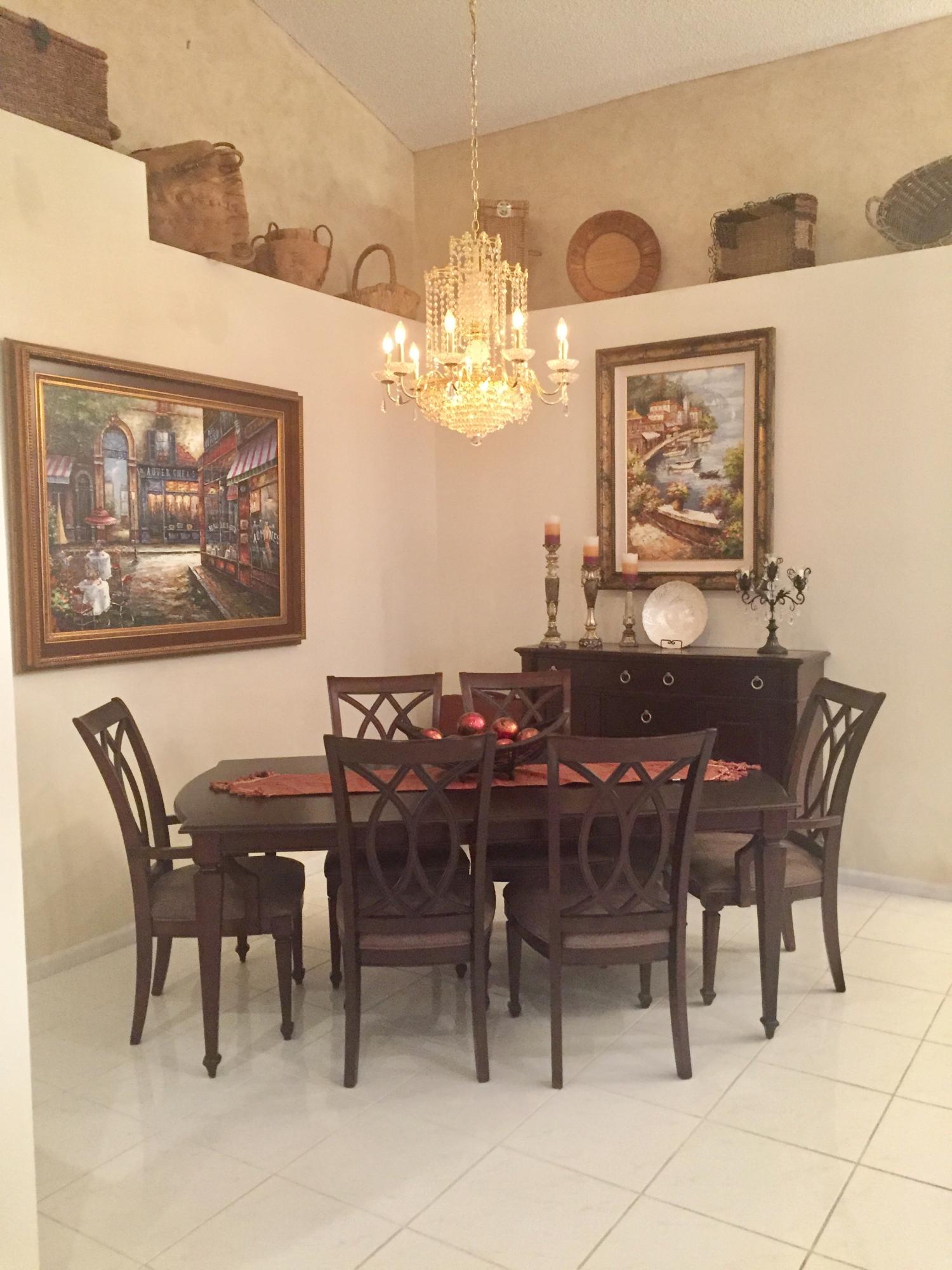 8349 Horseshoe Bay Road Boynton Beach, FL 33472 - Photo 8 of 20 a view of a dining room with furniture a chandelier and a chandelier