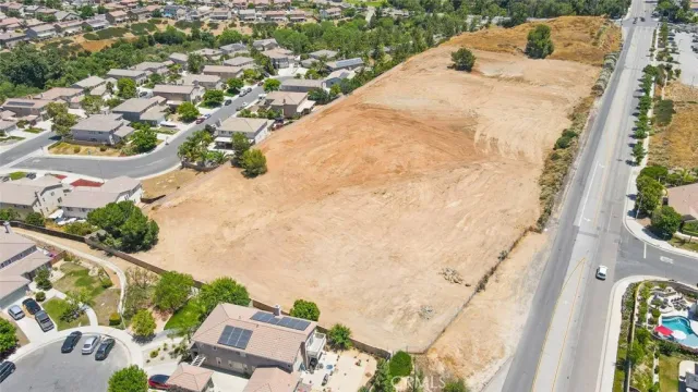 an aerial view of a house with swimming pool and ocean view