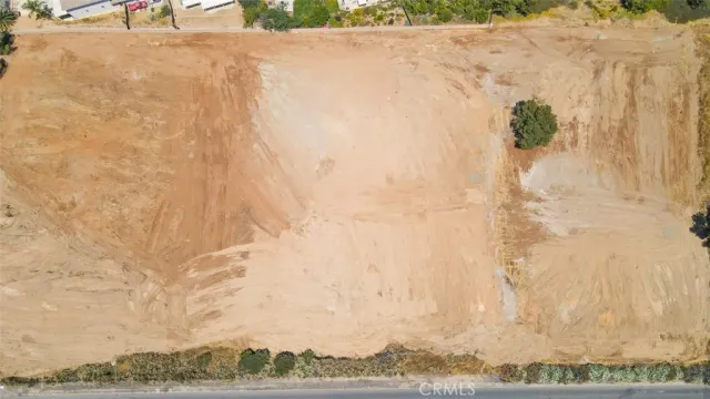 a view of a yard with wooden fence