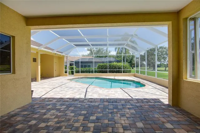 an aerial view of a house with yard swimming pool and outdoor seating