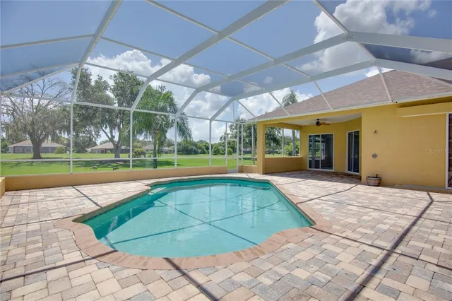 a front view of a house with a yard and potted plants