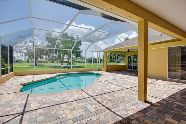 a front view of a house with a yard and potted plants