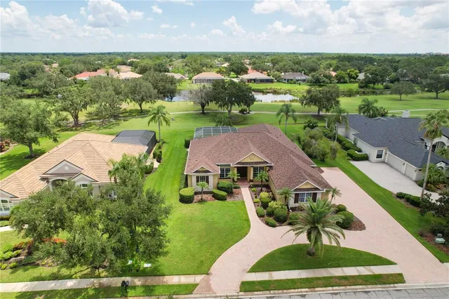 an aerial view of residential houses with outdoor space and river