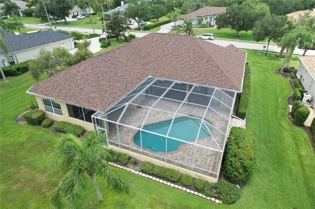 an aerial view of residential houses with outdoor space and river