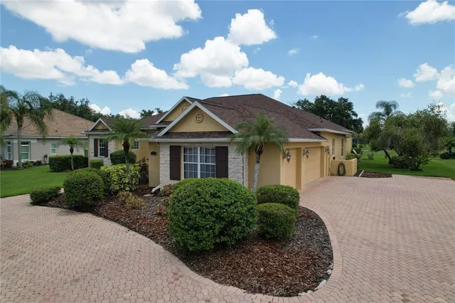 a front view of a house with a garden and yard