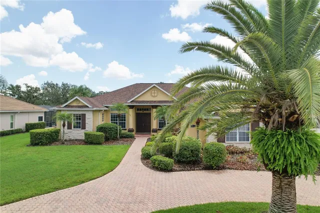 a front view of a house with yard and green space
