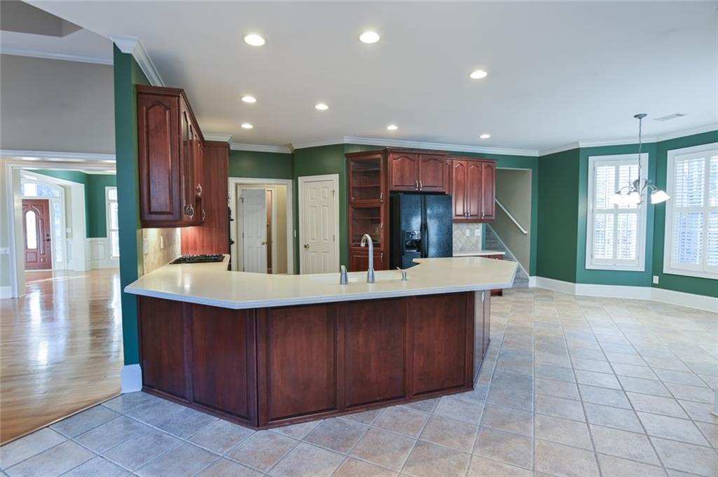 55 Glengarry Chase Covington, GA 30014 - Photo 21 of 73 a kitchen with kitchen island granite countertop a sink counter top space and cabinets