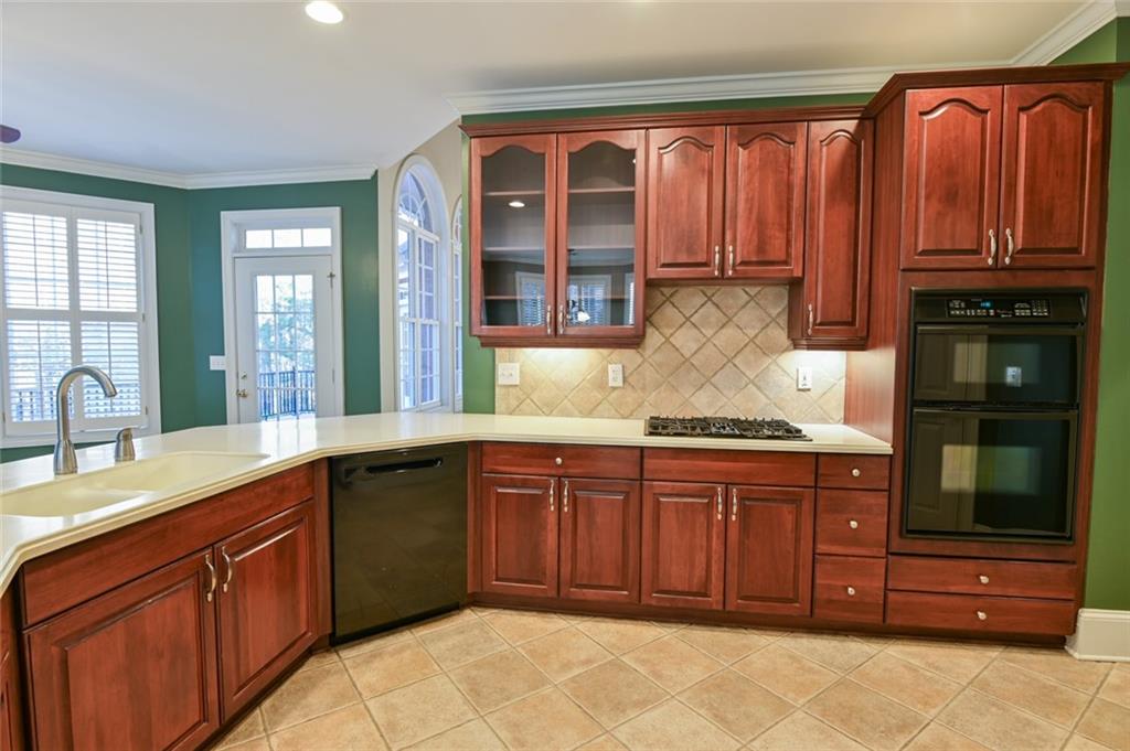 55 Glengarry Chase Covington, GA 30014 - Photo 25 of 73 a kitchen with stainless steel appliances granite countertop wooden cabinets a sink and dishwasher