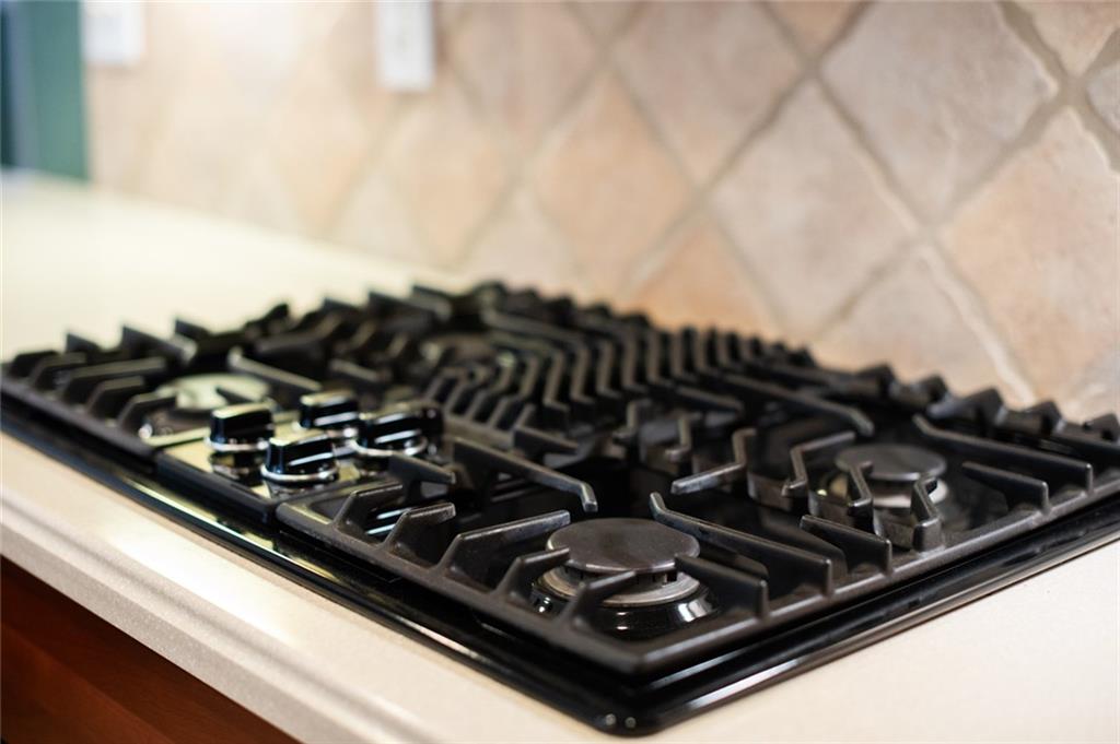 55 Glengarry Chase Covington, GA 30014 - Photo 26 of 73 a close up of a stove top oven sitting on a kitchen counter top