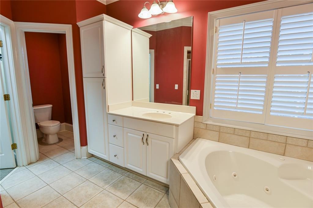 55 Glengarry Chase Covington, GA 30014 - Photo 42 of 73 a bathroom with a tub sink and mirror