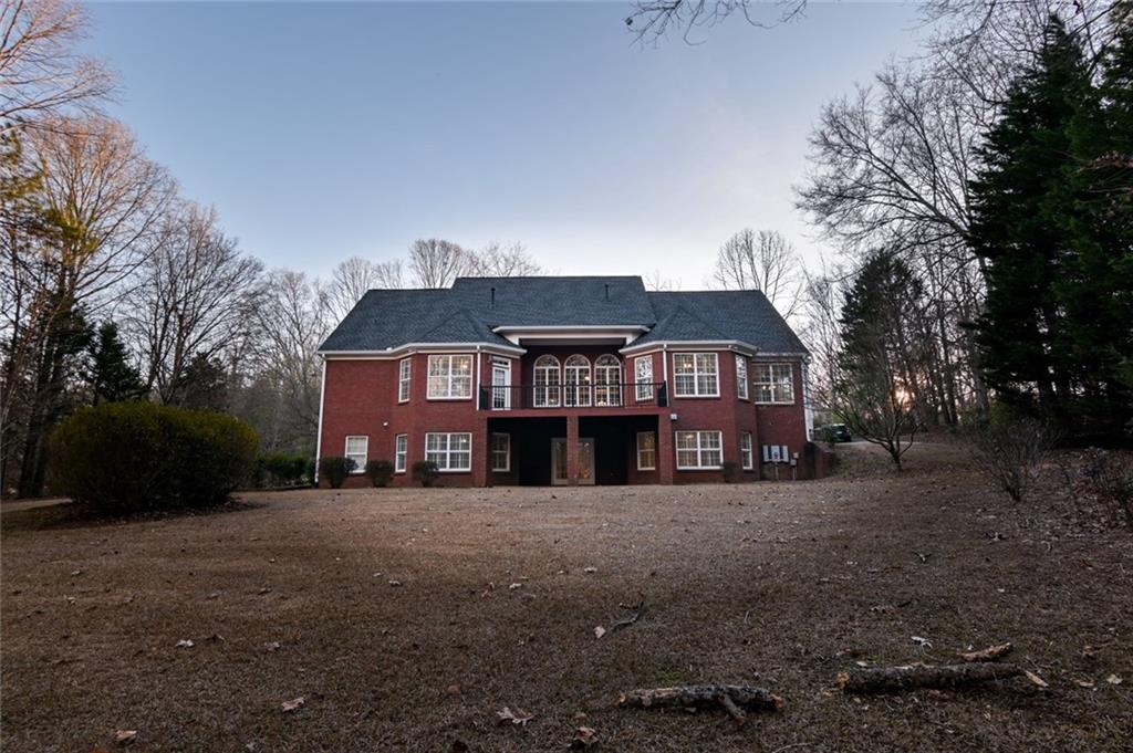 55 Glengarry Chase Covington, GA 30014 - Photo 53 of 73 a view of a big house with a big yard and large trees