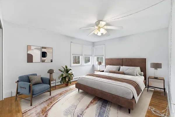 a bedroom with a bed couch and a window