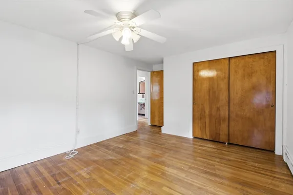 a view of an empty room with wooden floor