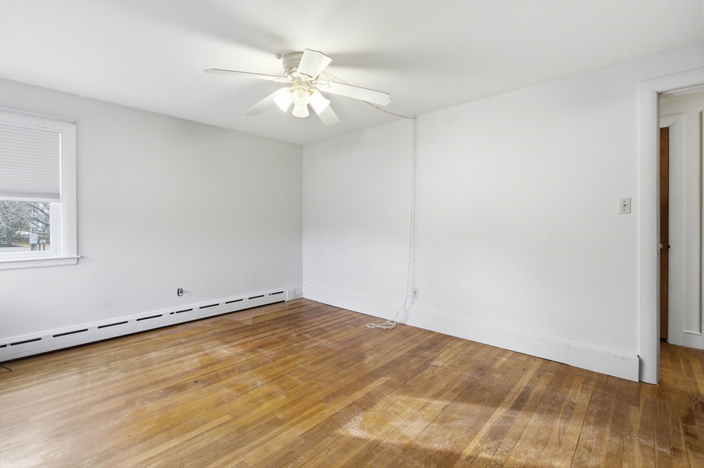 198 Conant Street Danvers, MA 01923 - Photo 17 of 32 an empty room with wooden floor and windows