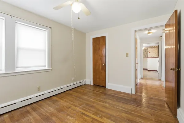 wooden floor in an empty room with a window