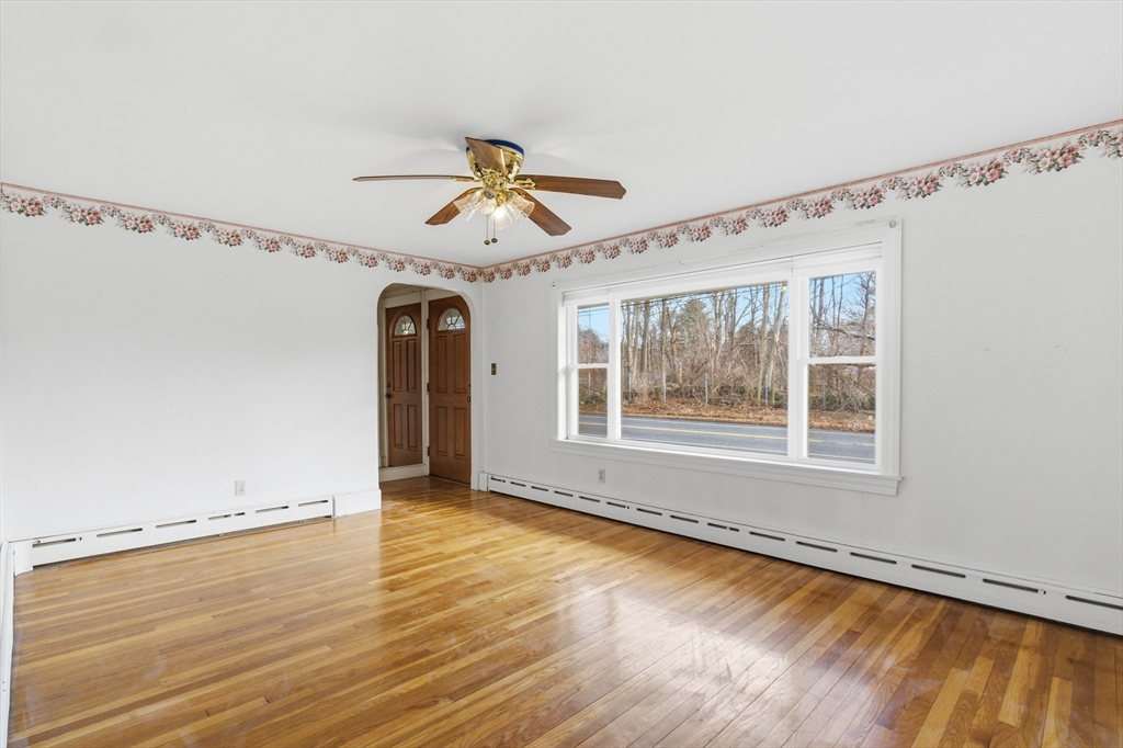 198 Conant Street Danvers, MA 01923 - Photo 5 of 32 a view of an empty room with a window and wooden floor