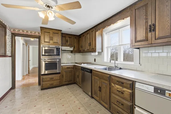 a kitchen with stainless steel appliances a sink stove and refrigerator