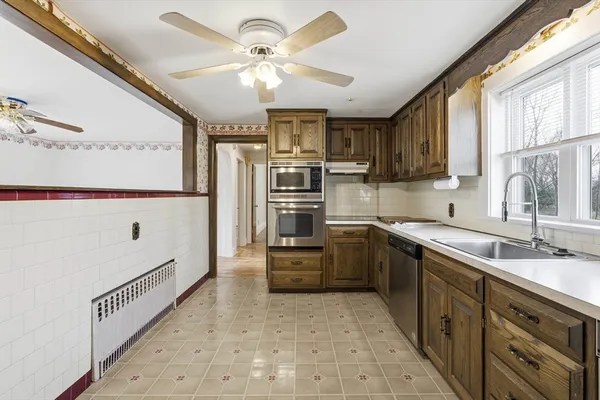 a kitchen with stainless steel appliances a refrigerator sink and cabinets