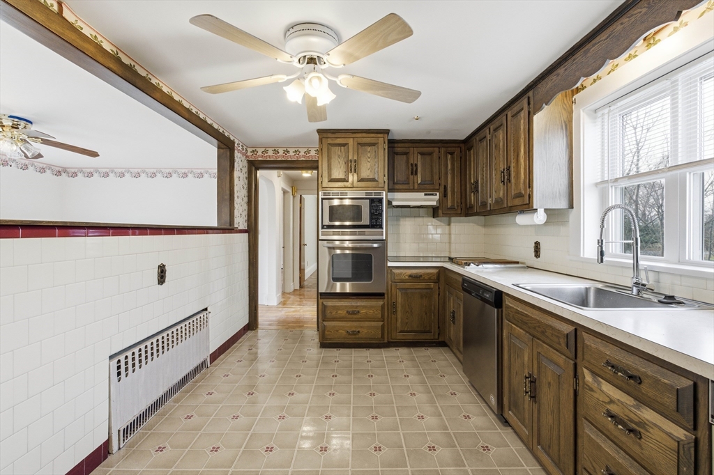 198 Conant Street Danvers, MA 01923 - Photo 9 of 32 a kitchen with stainless steel appliances a refrigerator sink and cabinets