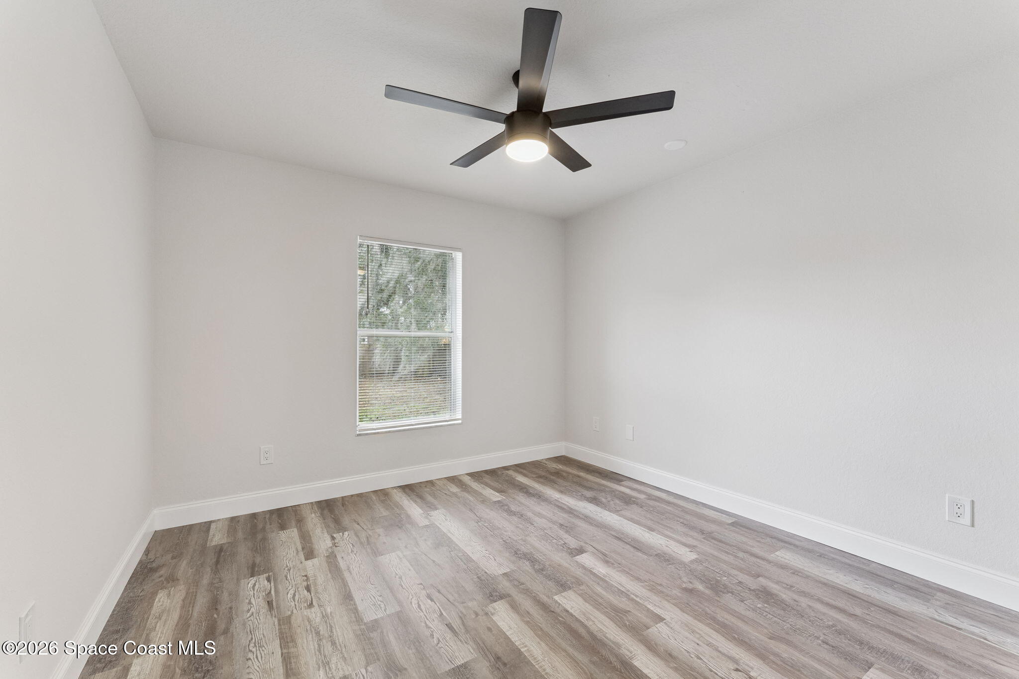 2665 Myrtle Avenue Mims, FL 32754 - Photo 11 of 23 an empty room with a window and a ceiling fan