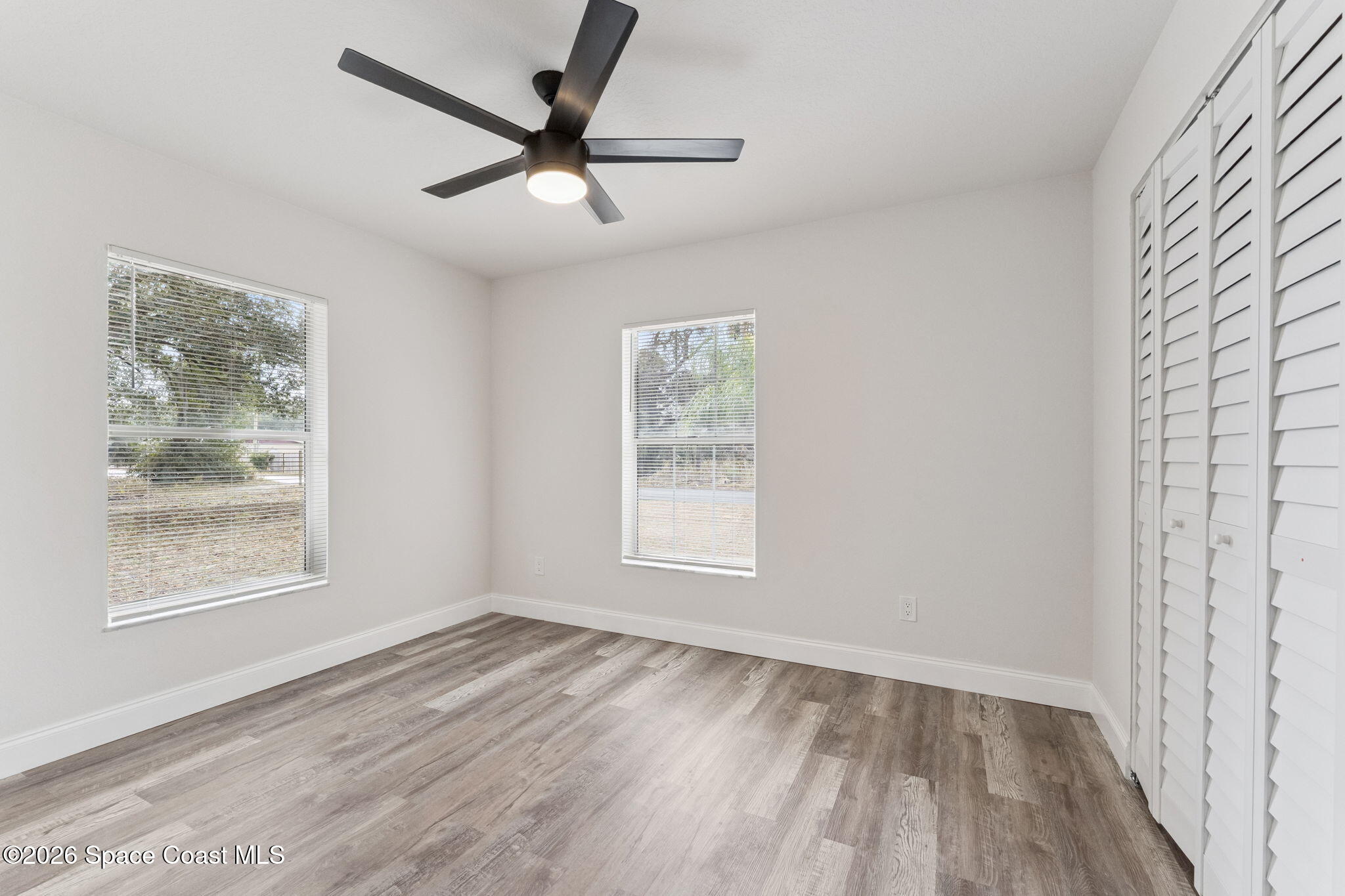 2665 Myrtle Avenue Mims, FL 32754 - Photo 13 of 23 a view of empty room with wooden floor and fan