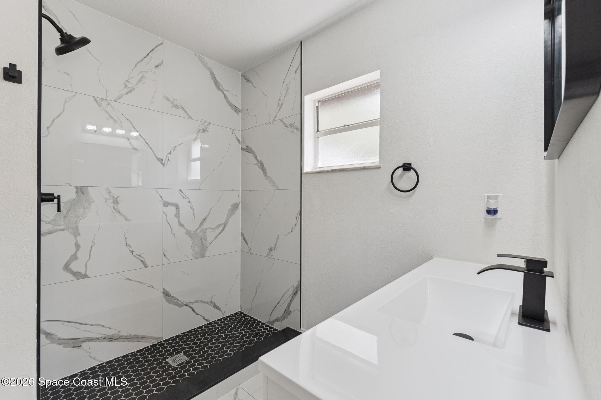 2665 Myrtle Avenue Mims, FL 32754 - Photo 16 of 23 a bathroom with a sink and a shower